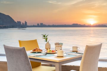 a table with food on it and a view of the water