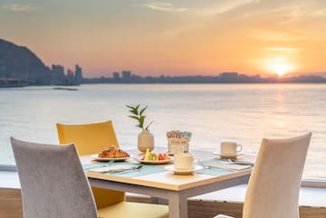 a table with food on it and a view of the water
