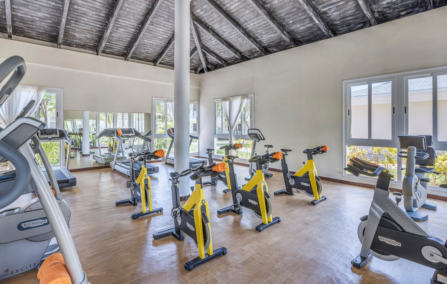 a room with exercise bikes and a large window
