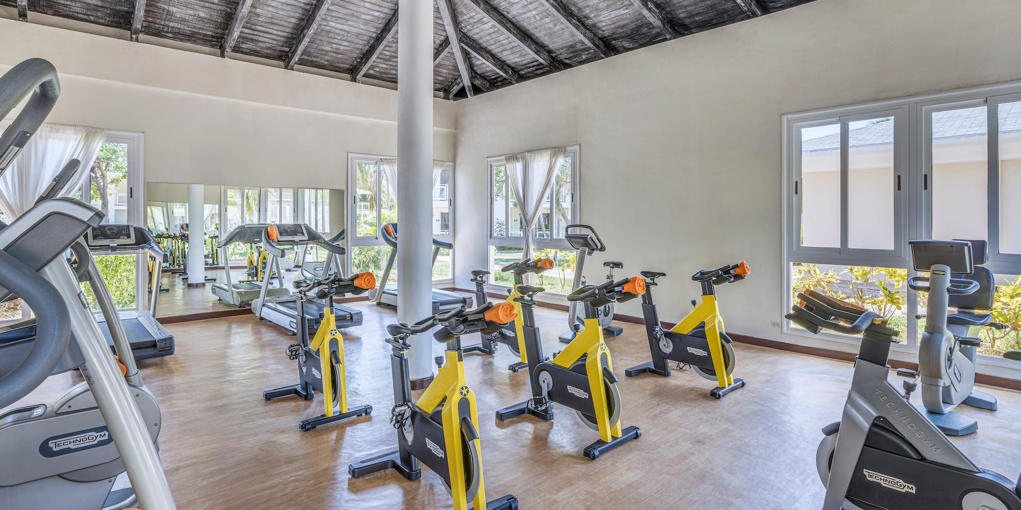 a room with exercise bikes and a large window
