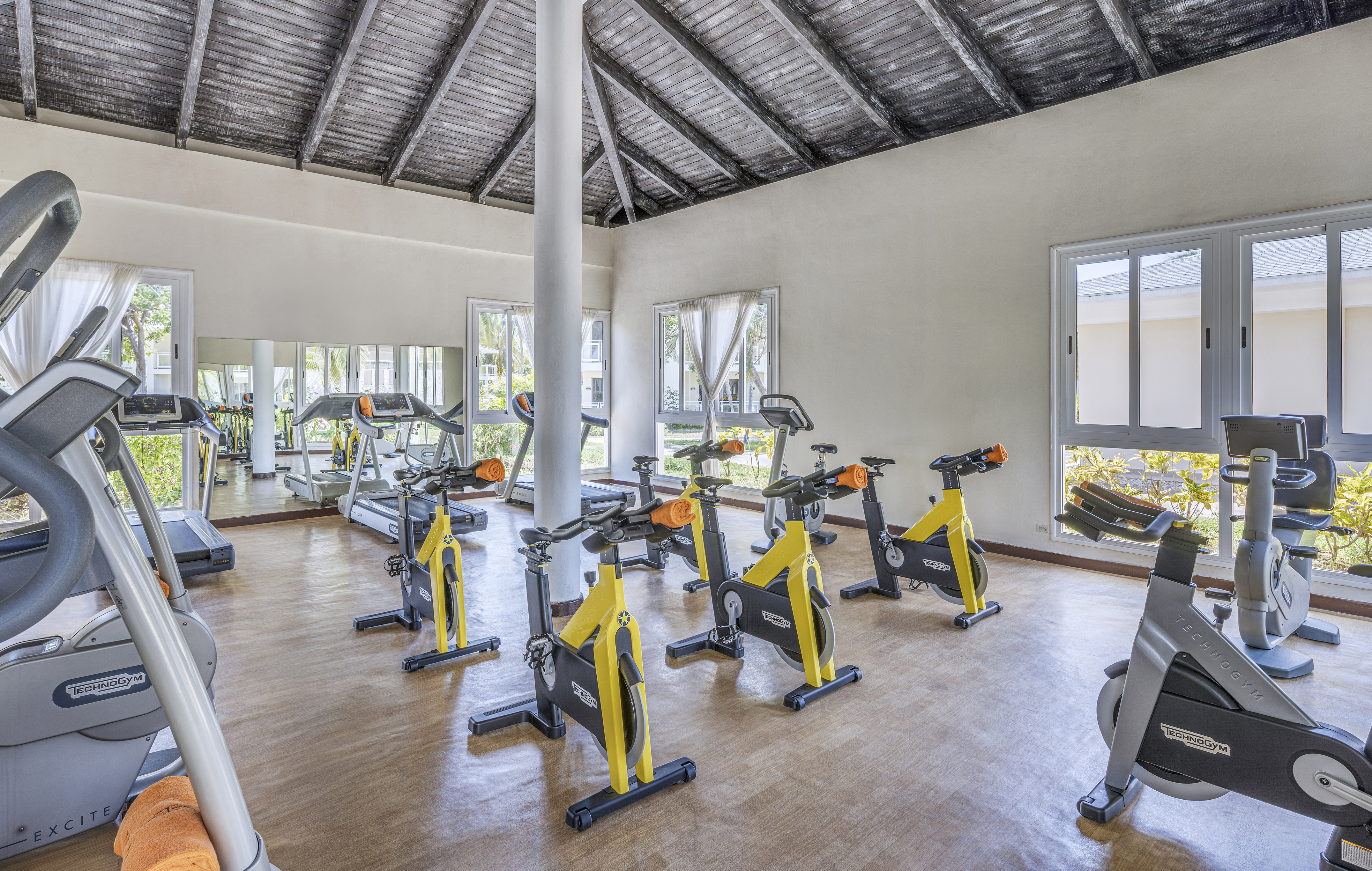 a room with exercise bikes and a large window