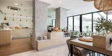 a restaurant with a large counter and chairs