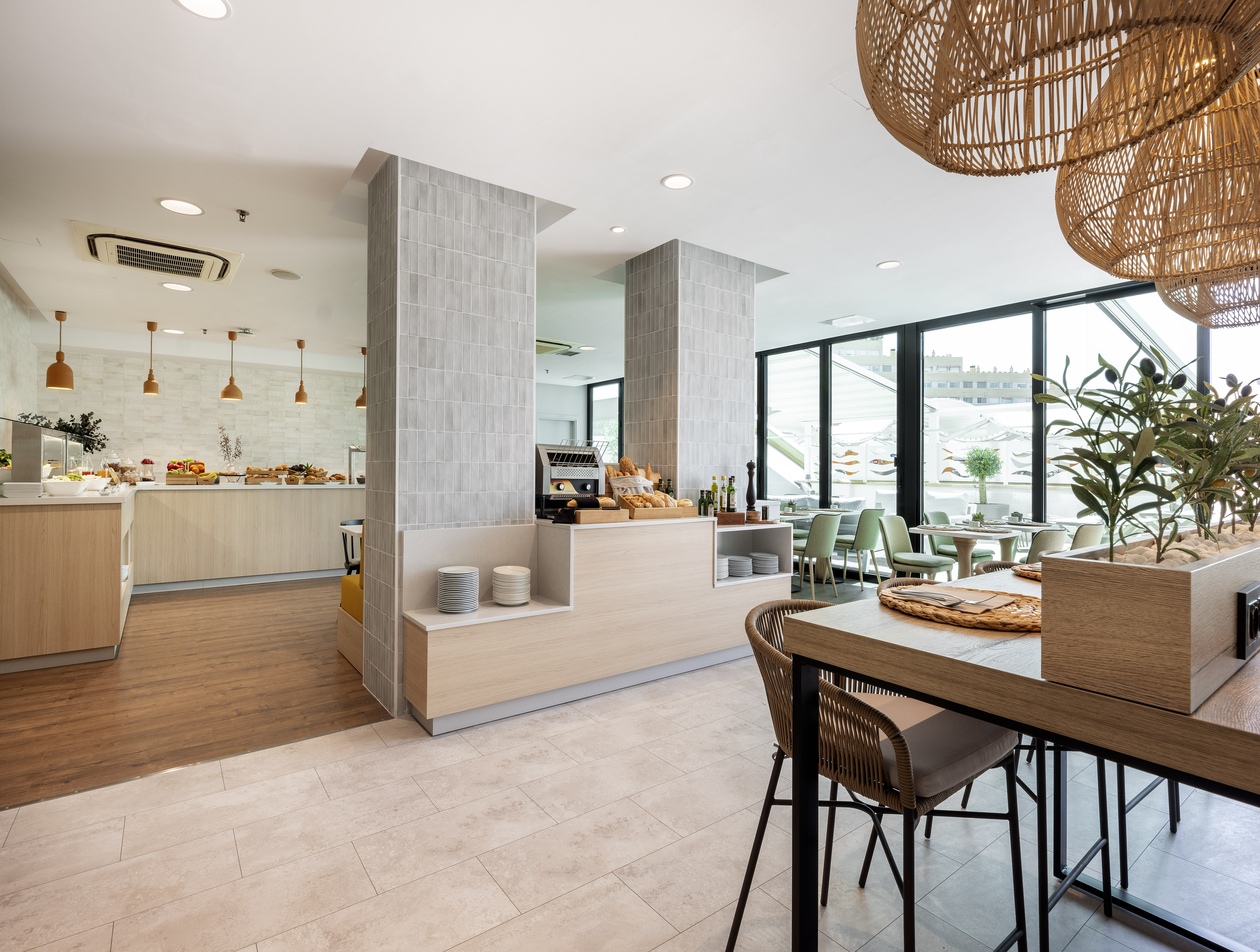 Modern hotel breakfast buffet and bright dining area with food stations.