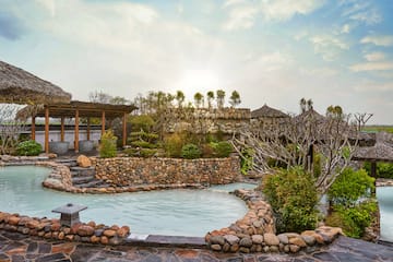 a pool with a stone wall and a stone structure