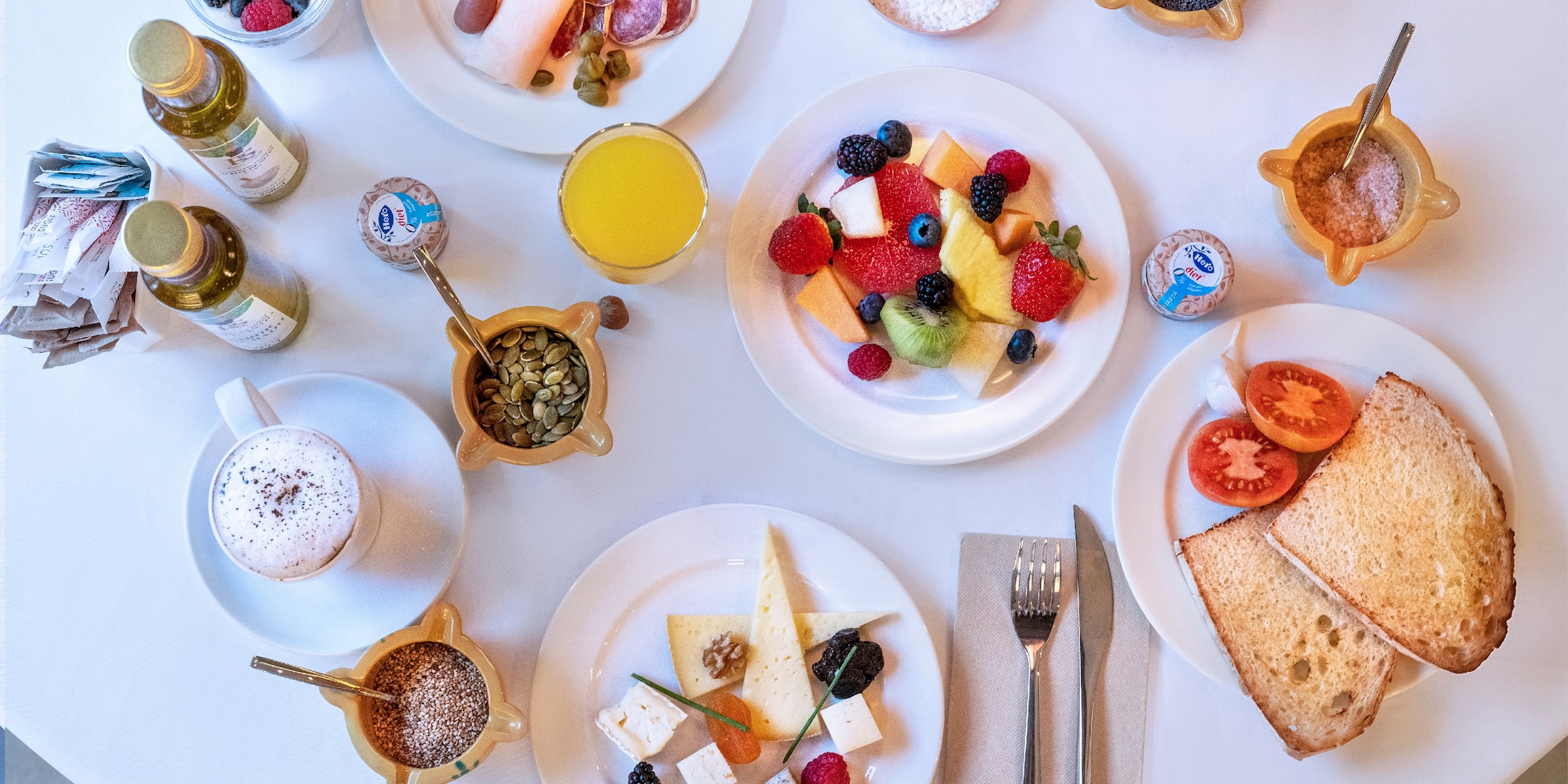 a table with plates of food and drinks