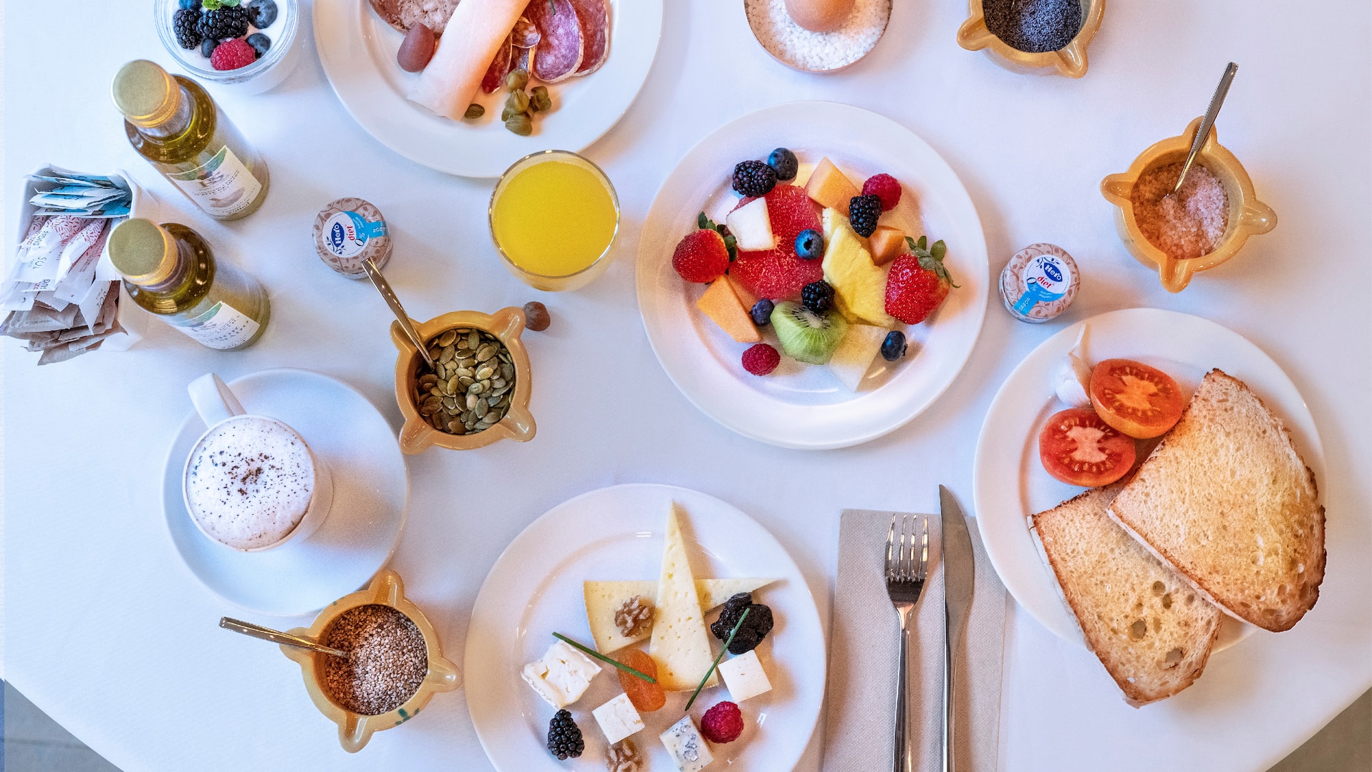 a table with plates of food and drinks