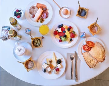 a table with plates of food and drinks