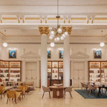 a room with a library and bookshelves