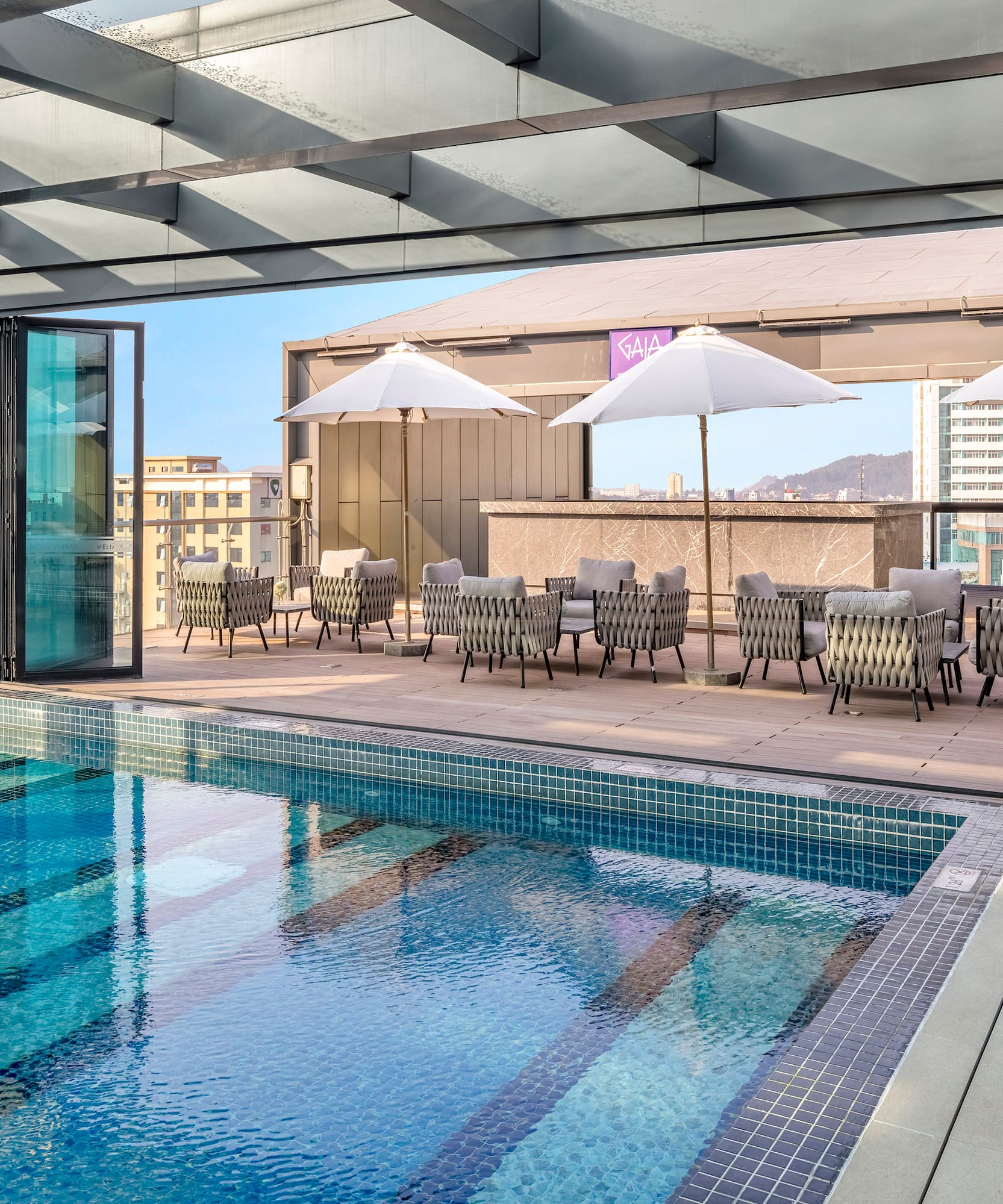 a pool with chairs and umbrellas