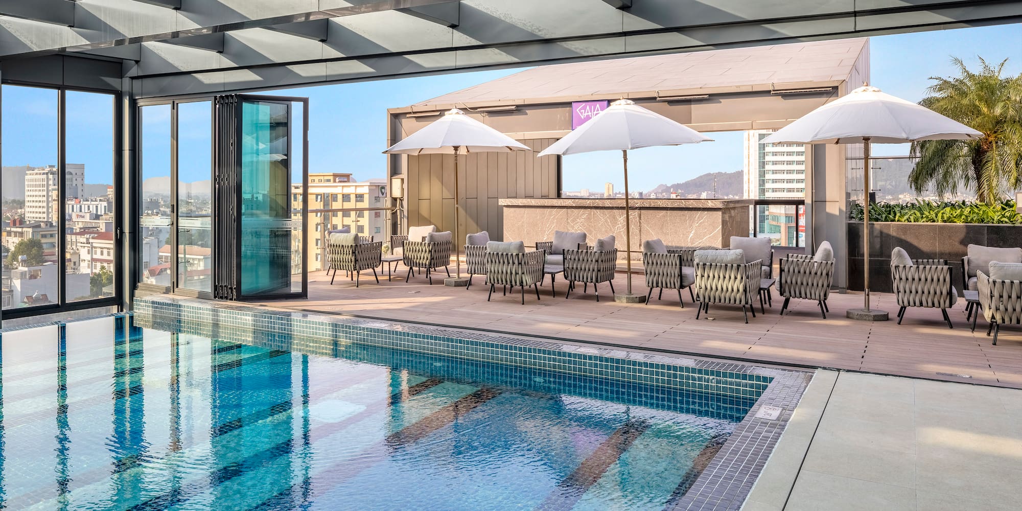 a pool with chairs and umbrellas