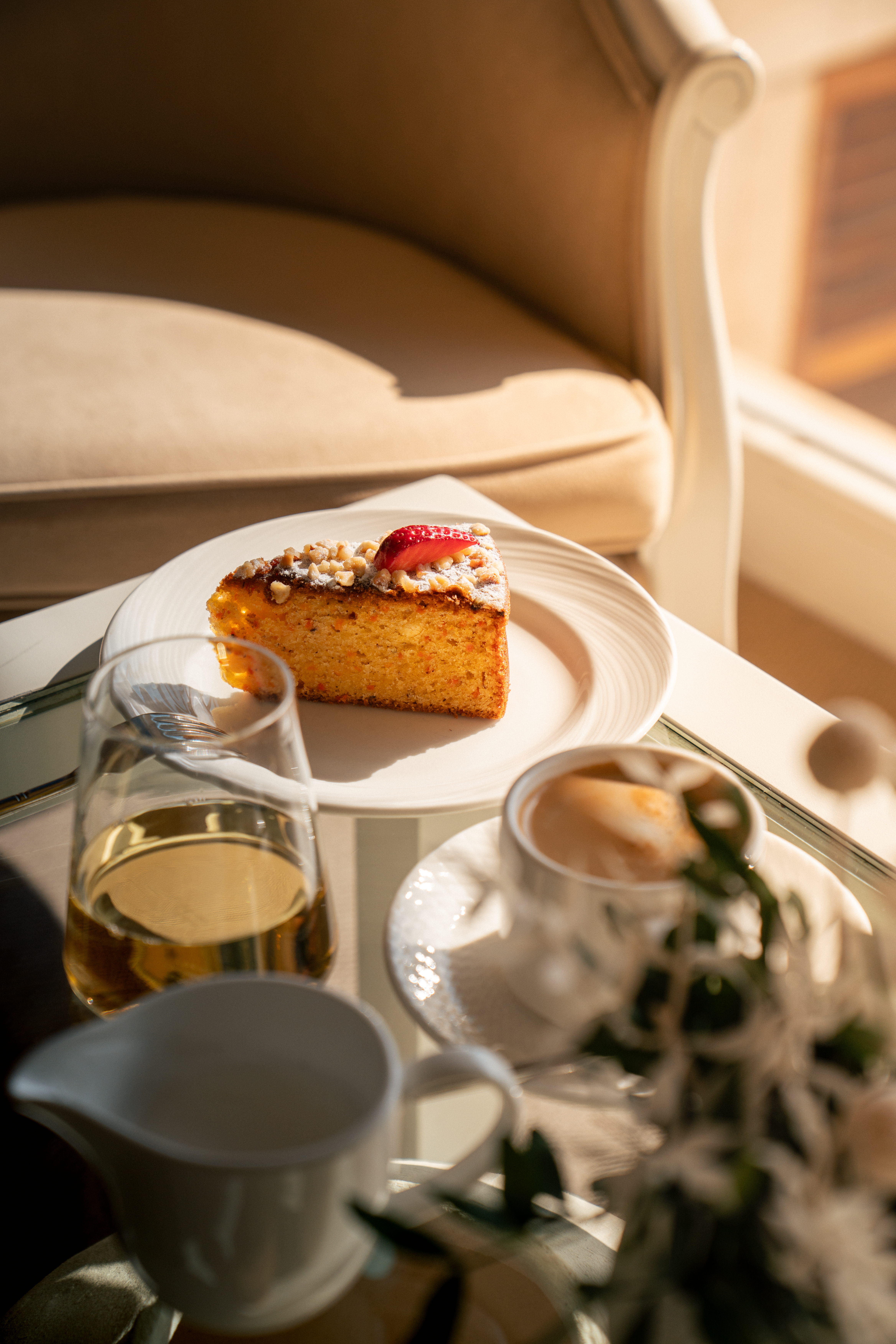 a piece of cake on a plate next to a cup of coffee