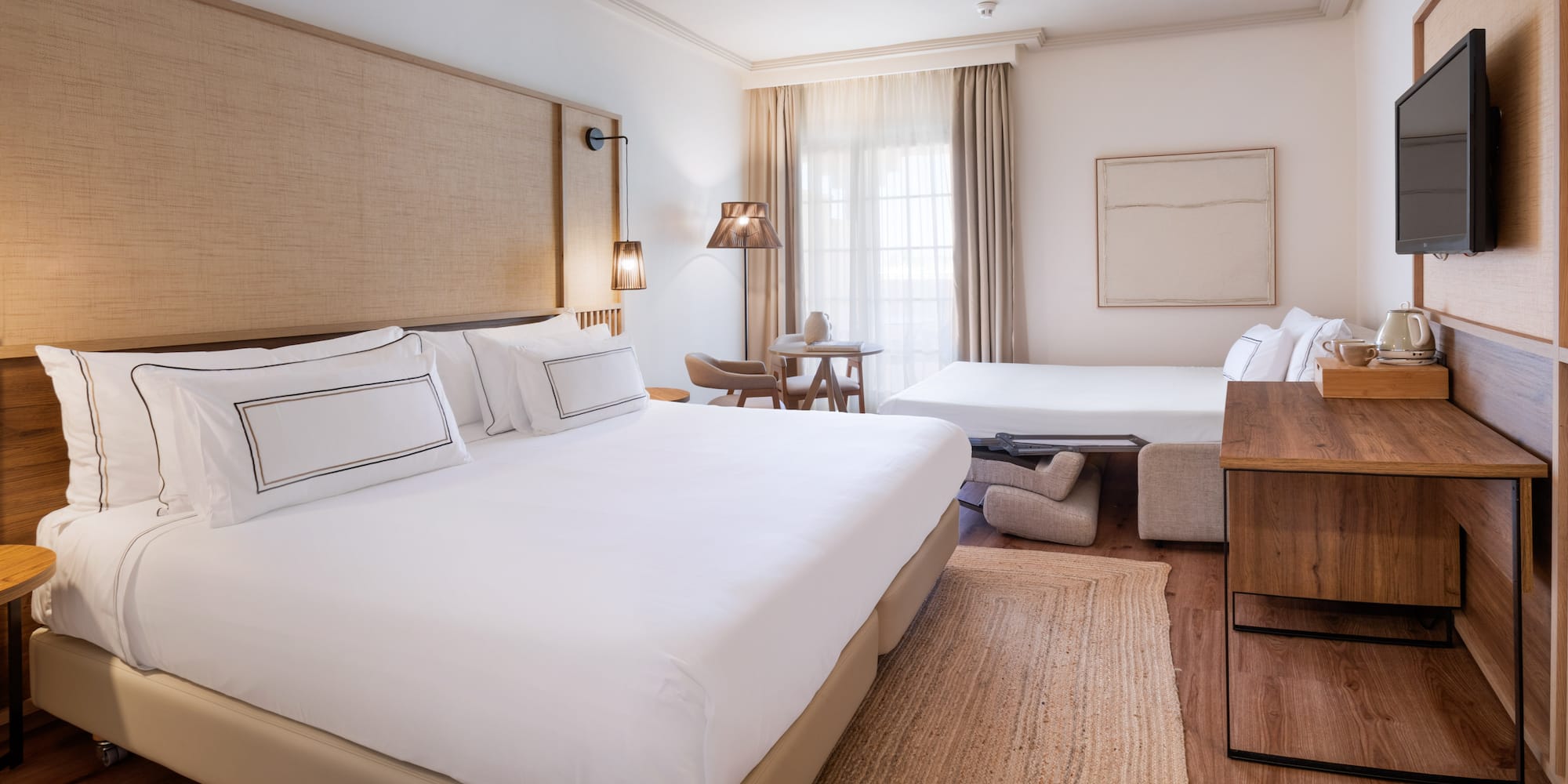 a room with two beds and a fan