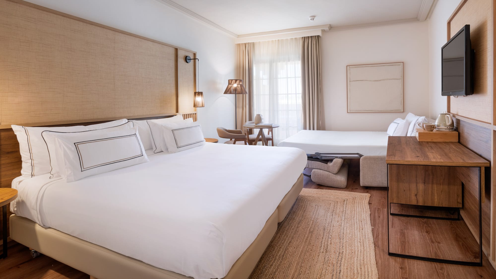 a room with two beds and a fan