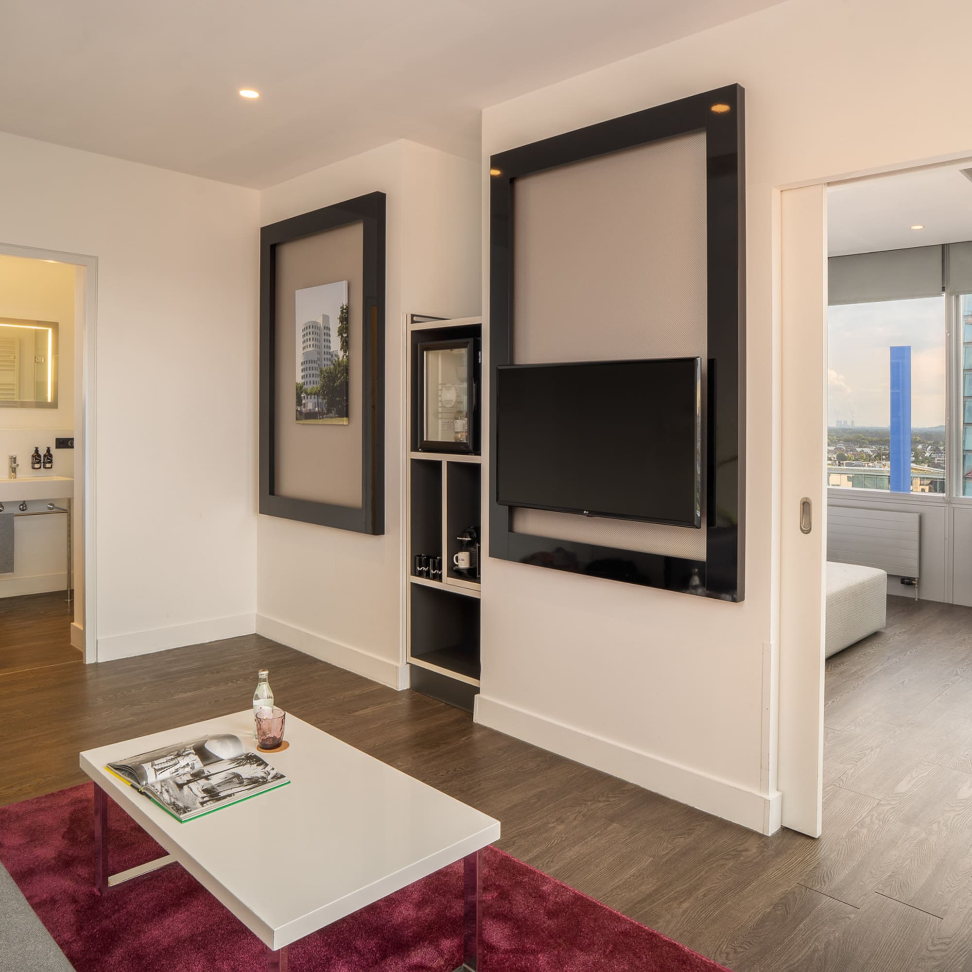 a living room with a tv on the wall