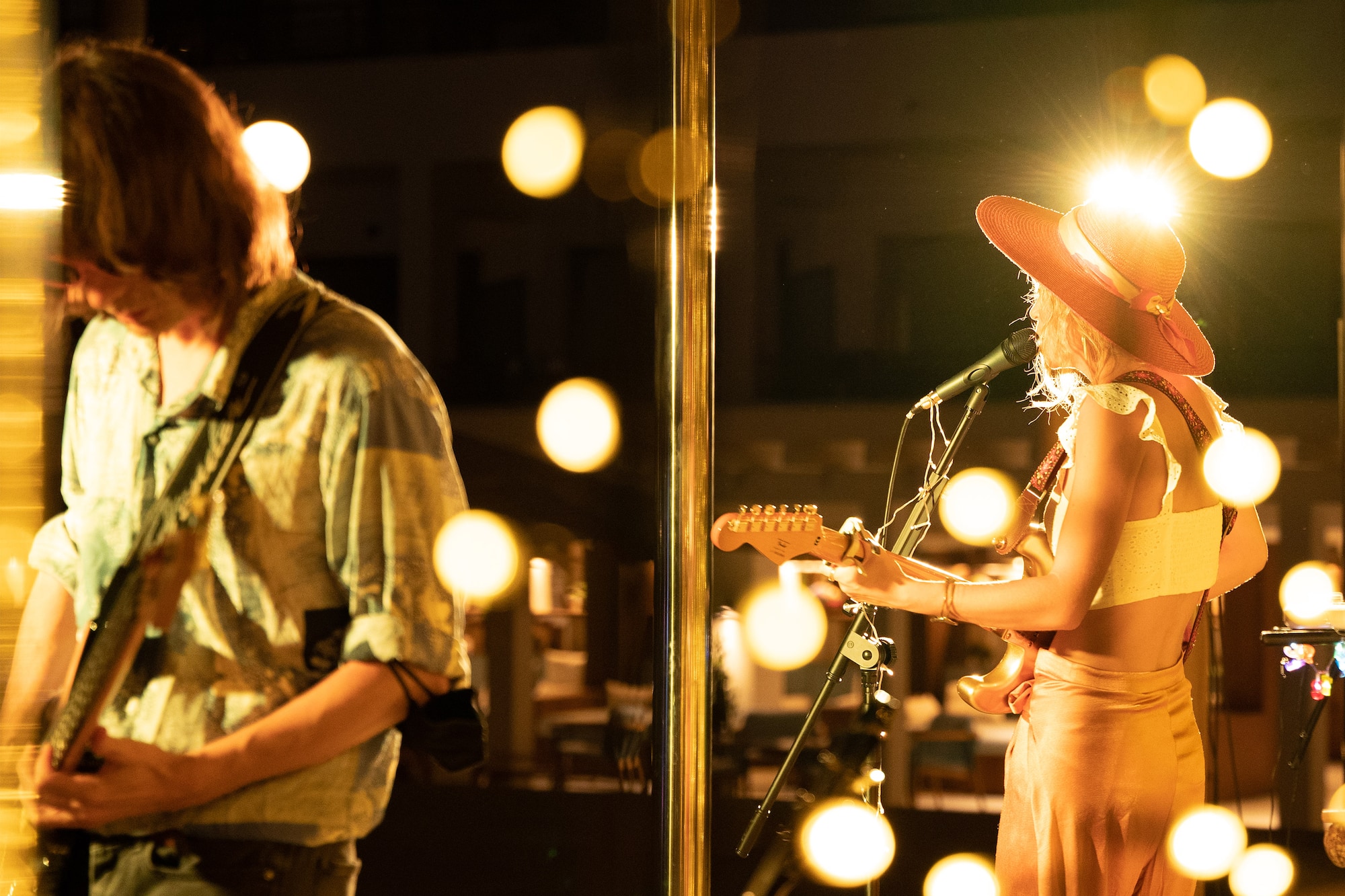 a woman playing guitar and a man playing a guitar