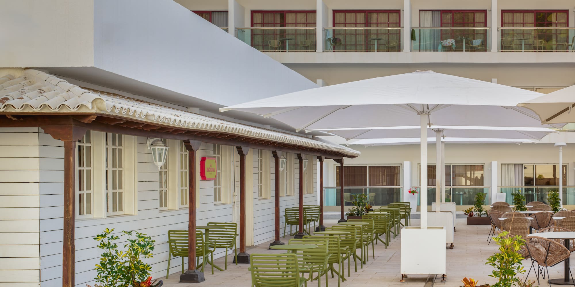 a patio with chairs and umbrellas