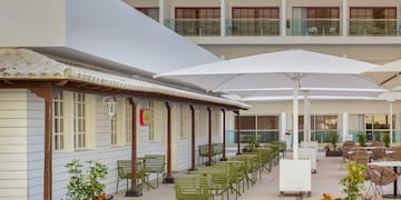 a patio with chairs and umbrellas