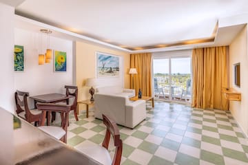 a room with a couch and chairs and a table