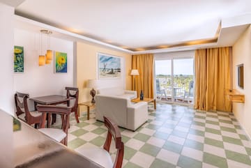 a room with a couch and chairs and a table