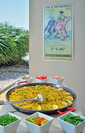 a large pan of food with a poster on the wall