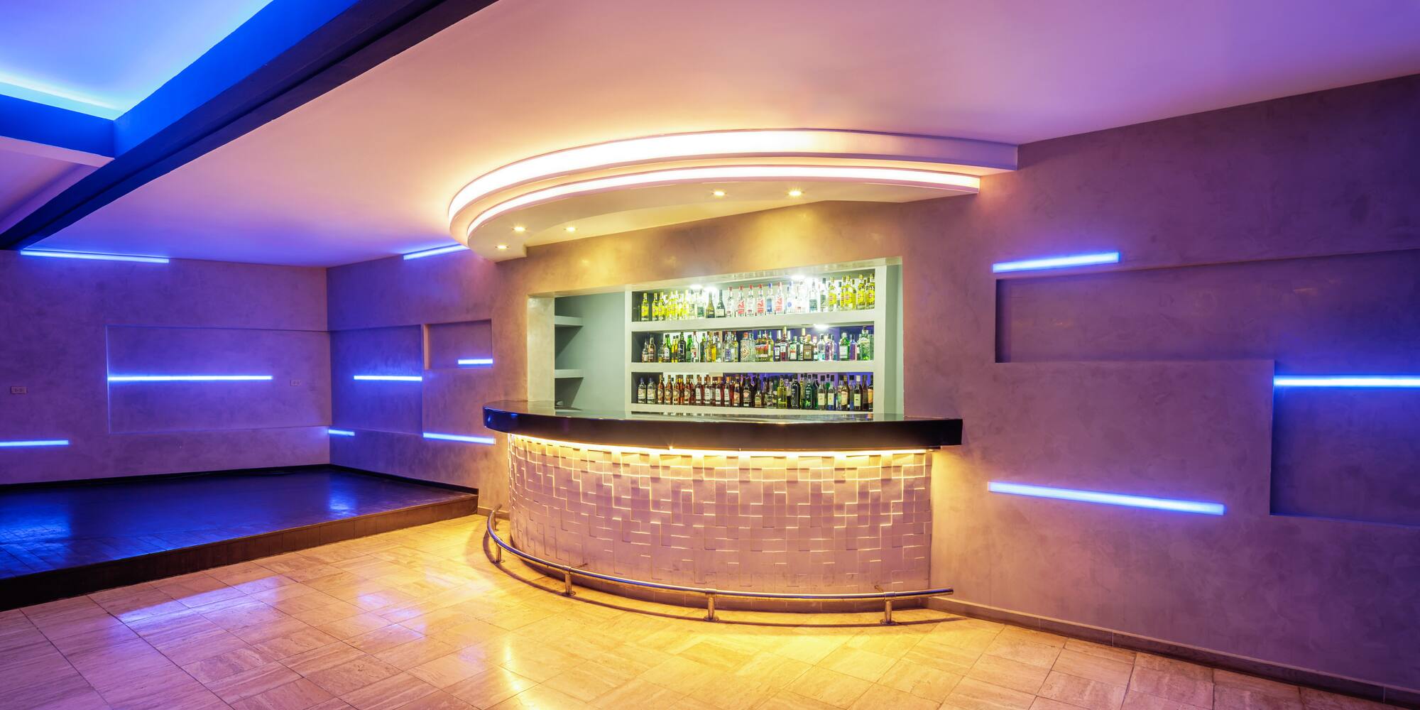 a bar with bottles on the counter