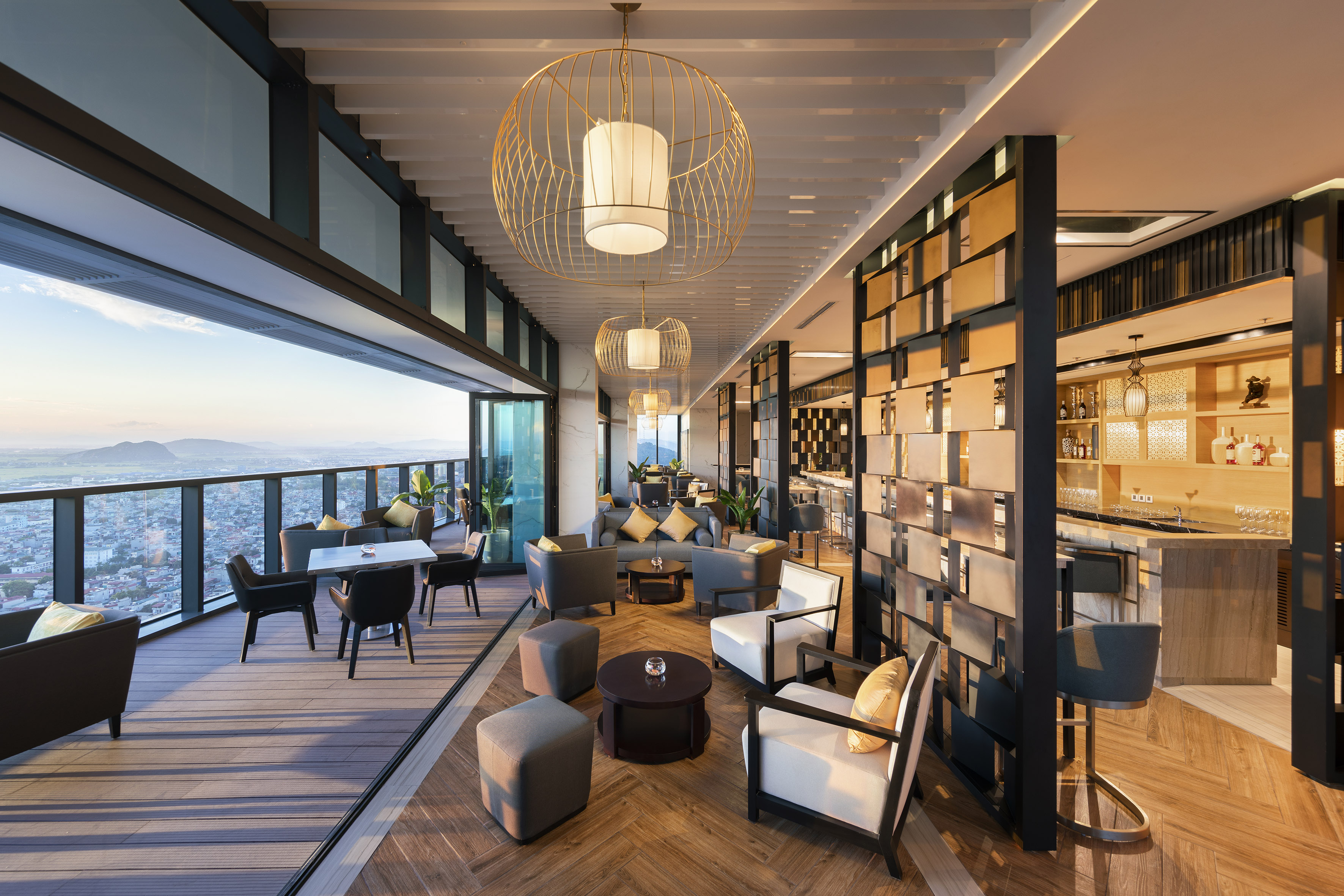 Modern rooftop lounge bar with cityscape view and outdoor seating.