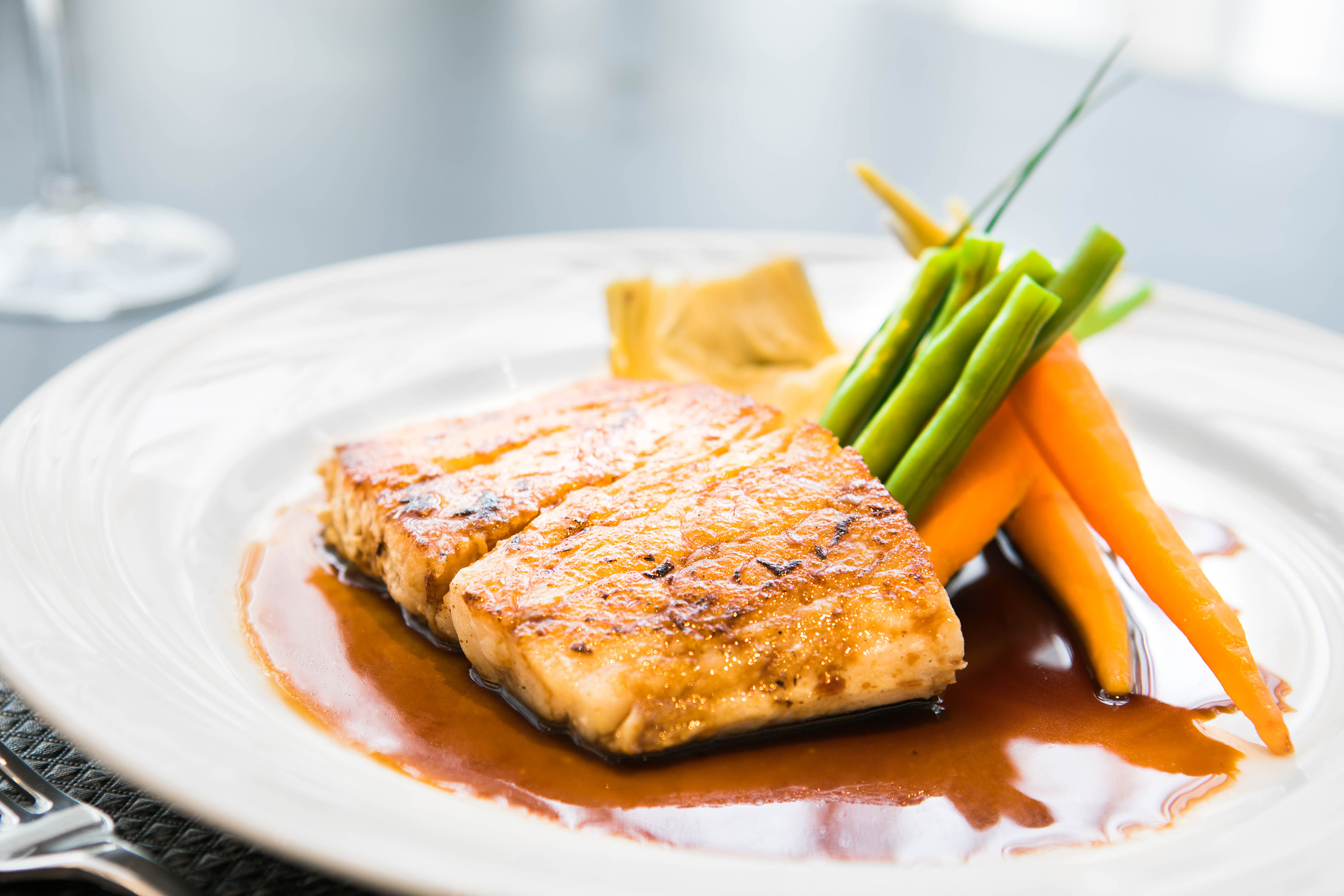 a plate of food with sauce and vegetables