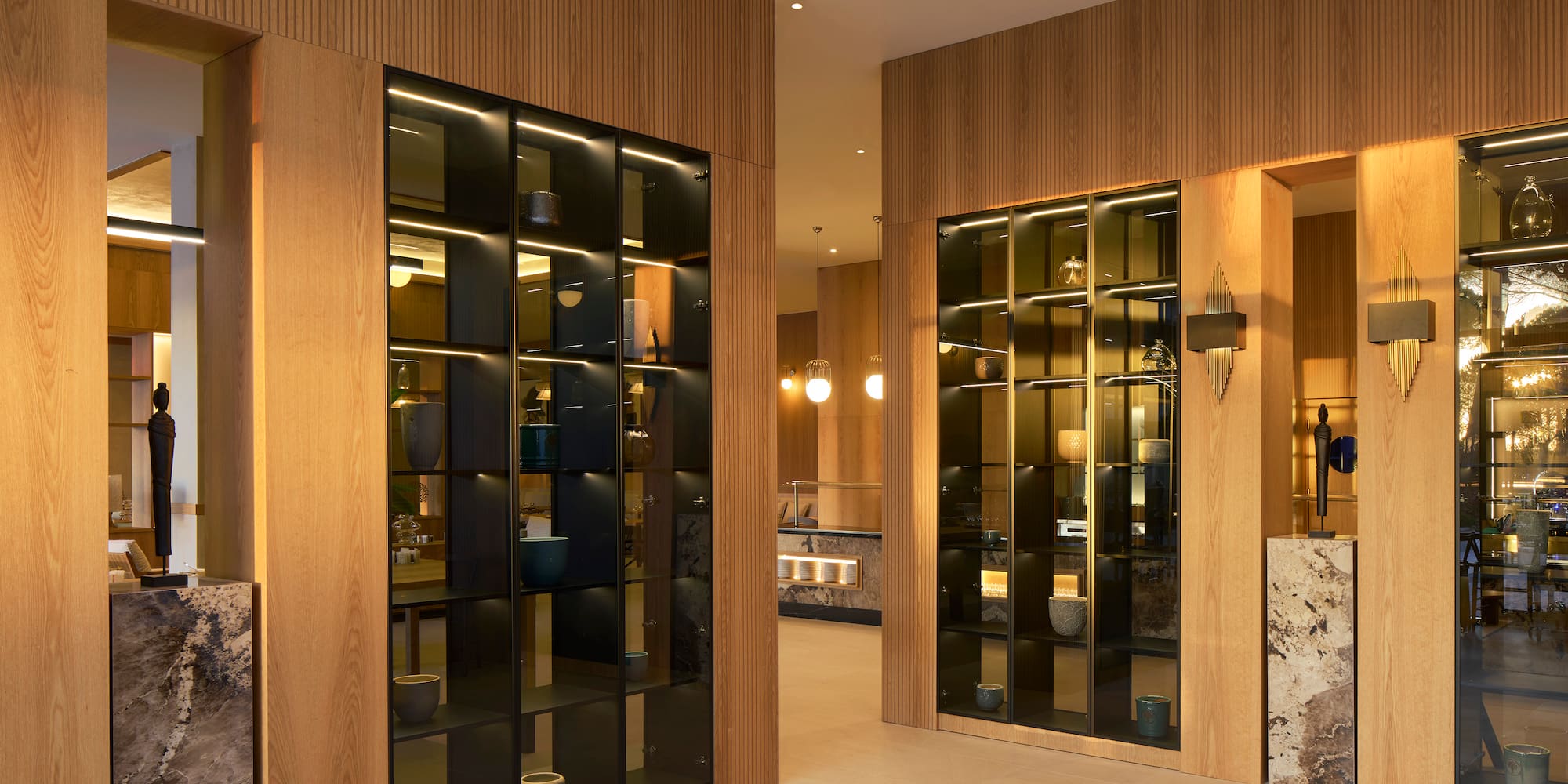 a room with glass doors and a wood wall