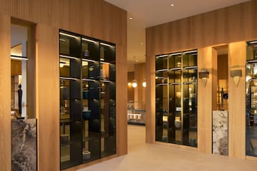a room with glass doors and a wood wall