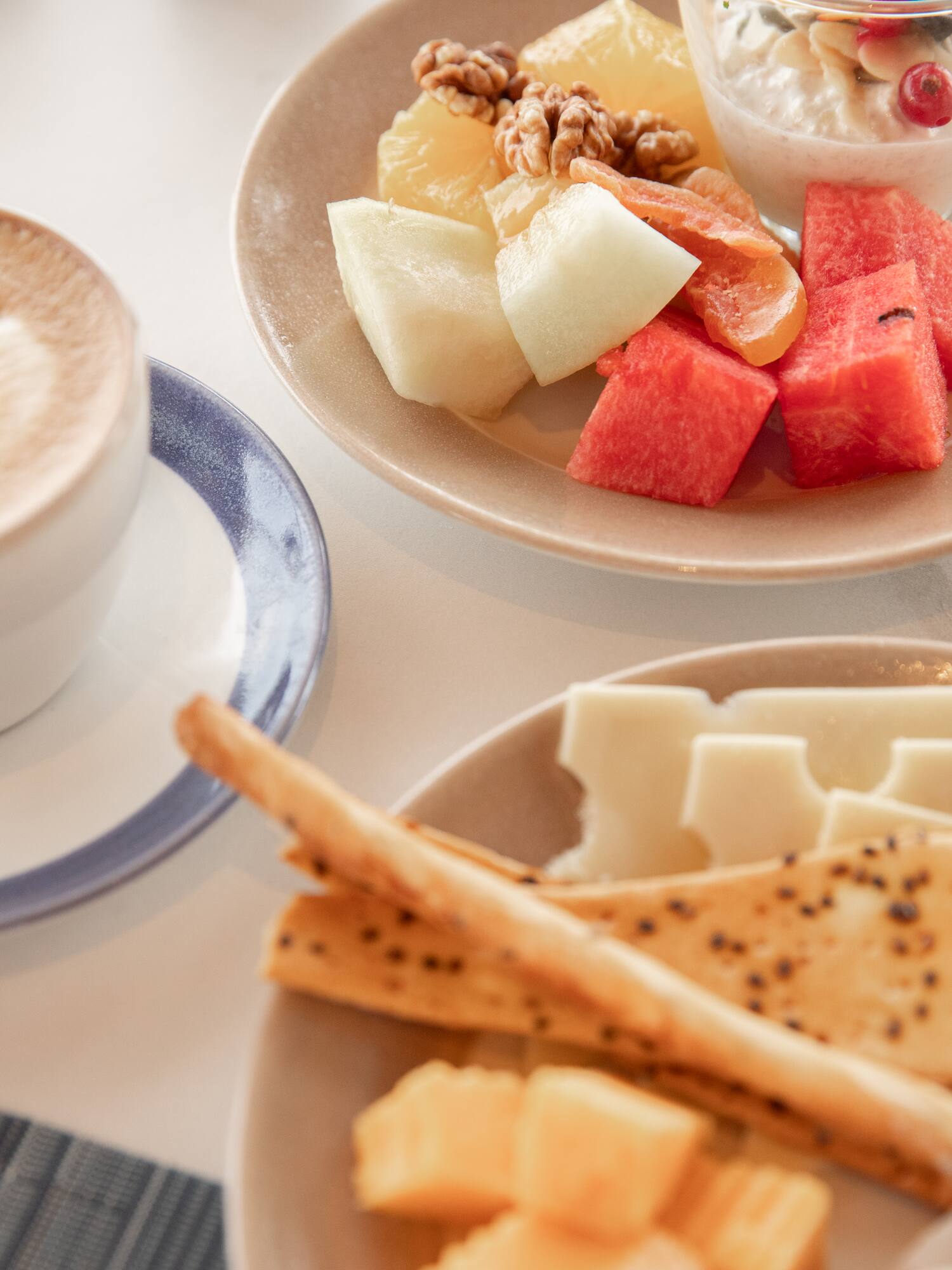 a plate of fruit and cheese on a table