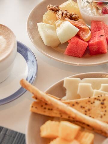 a plate of fruit and cheese on a table