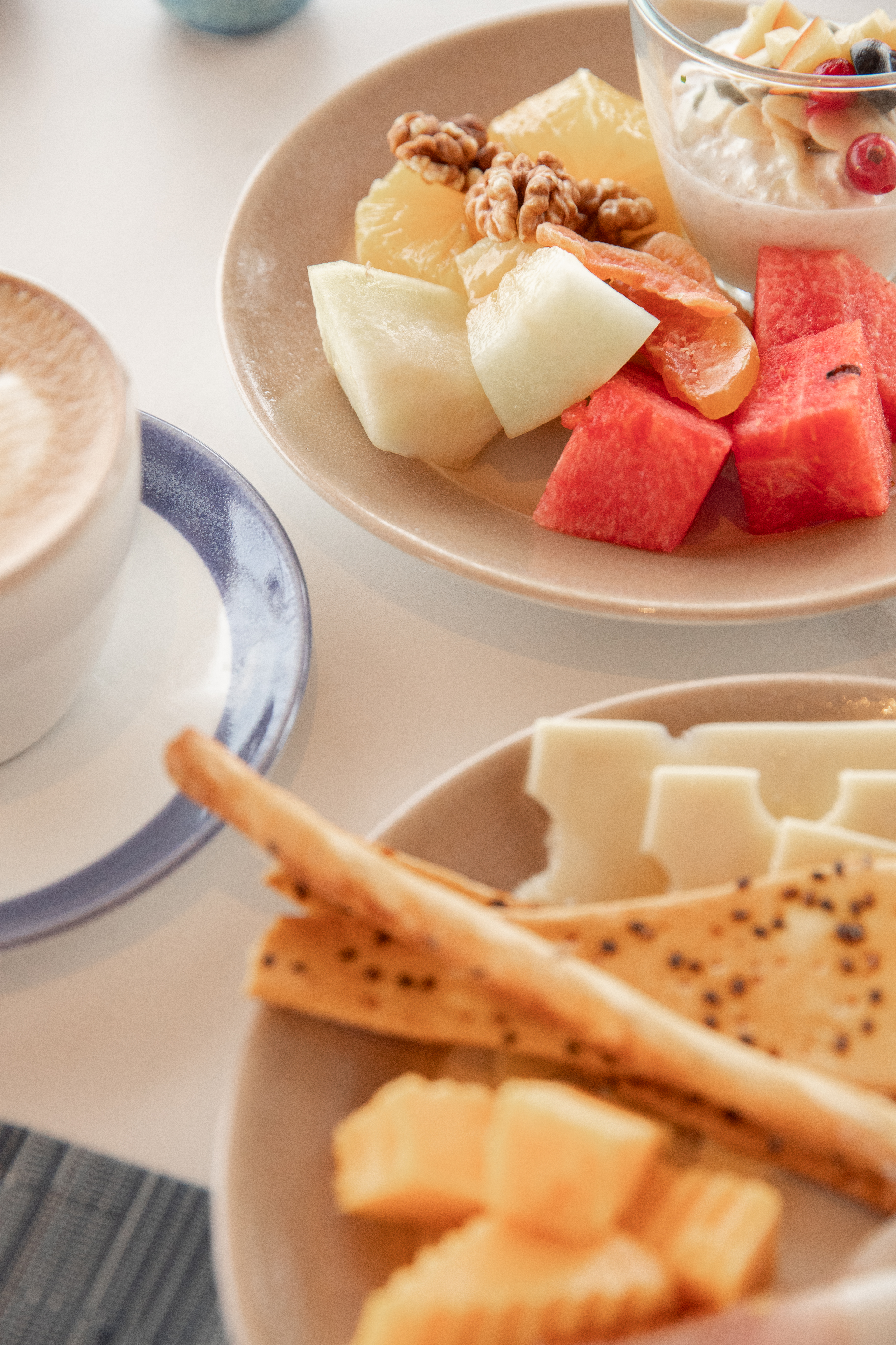 a plate of fruit and cheese on a table