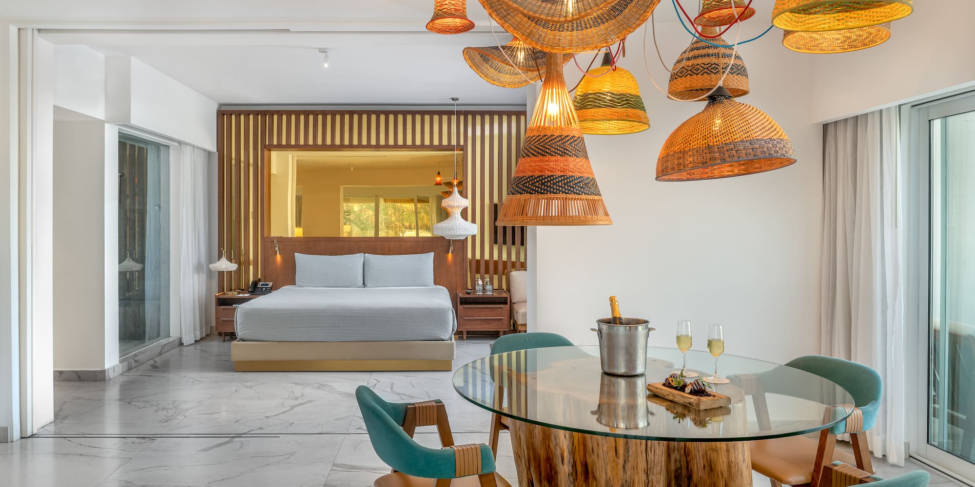 a room with a bed and a table and chairs