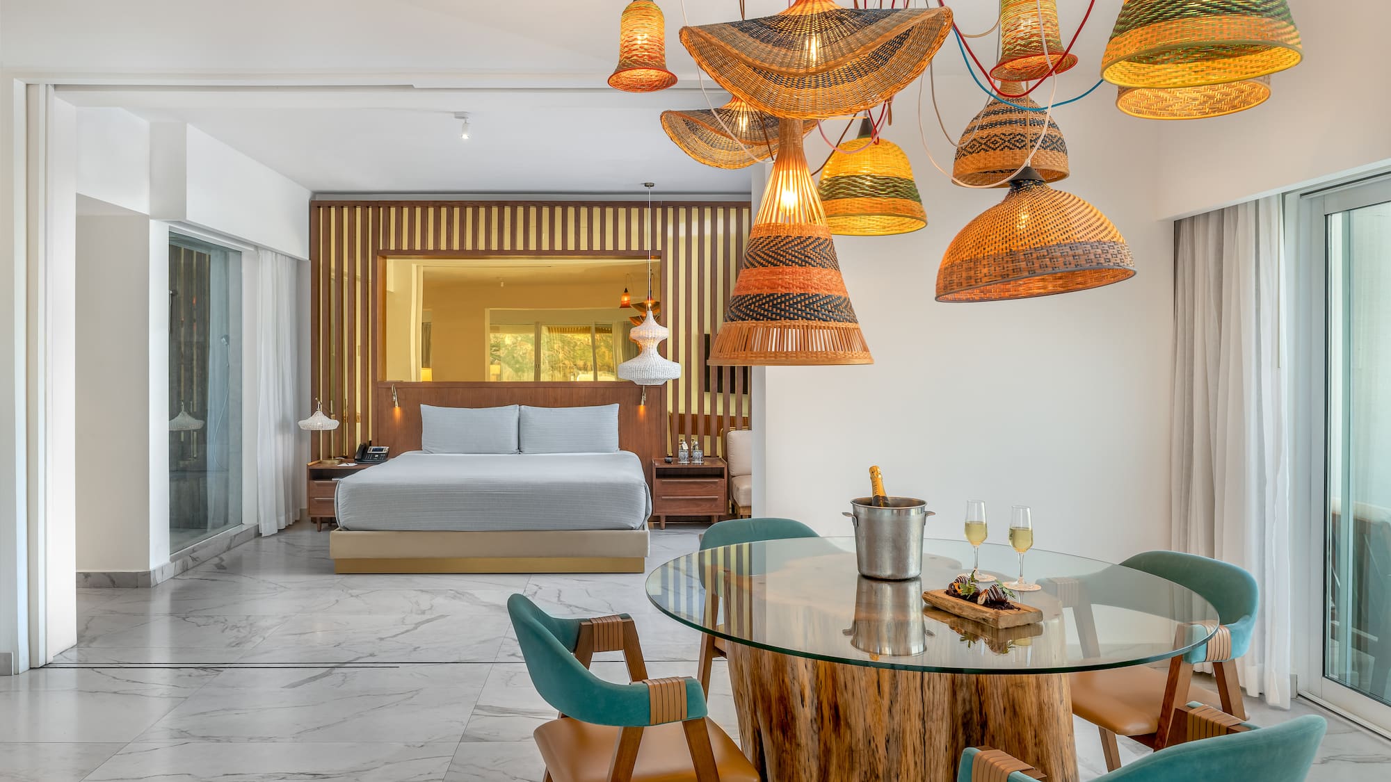 a room with a bed and a table and chairs