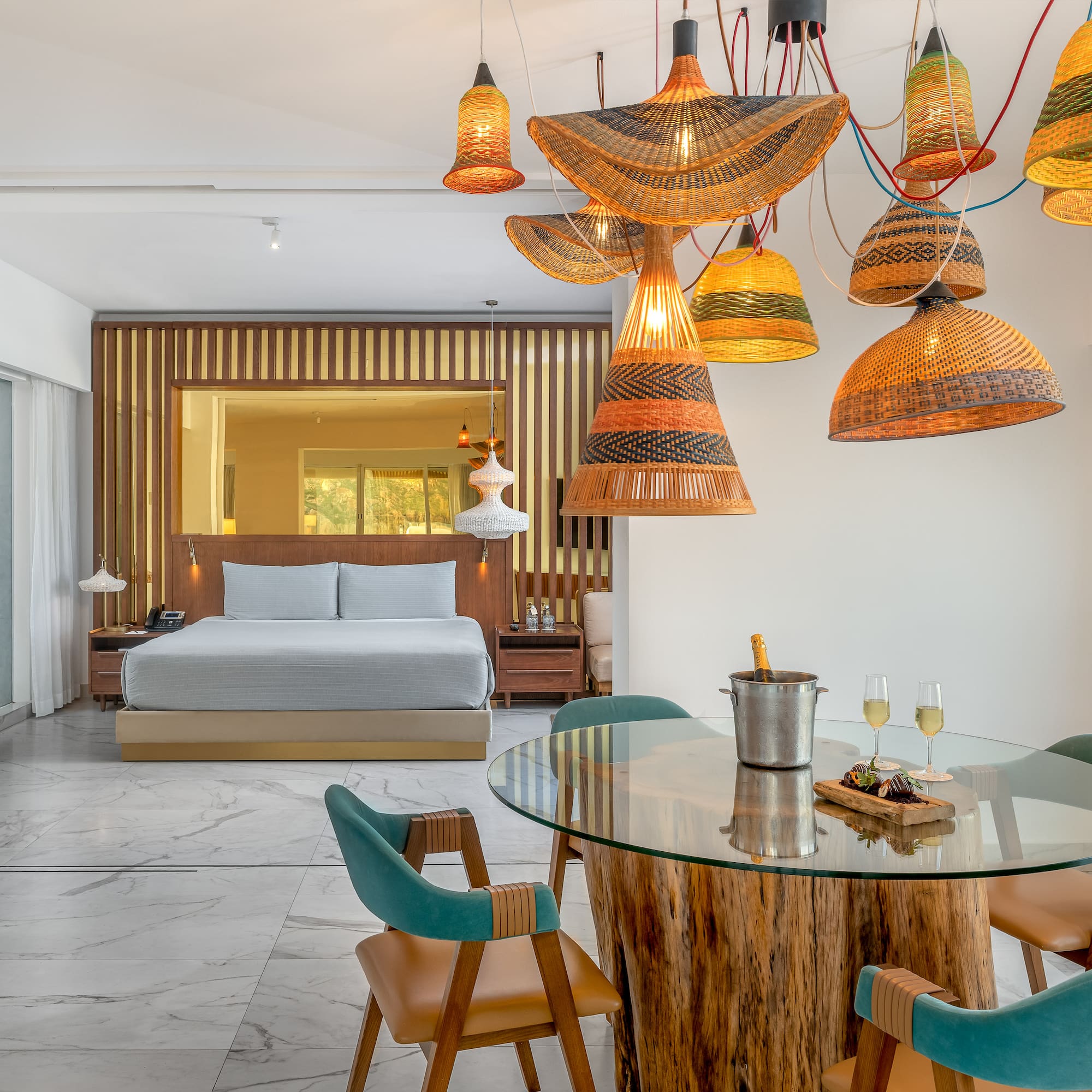 a room with a bed and a table and chairs