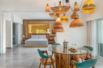 a room with a bed and a table and chairs