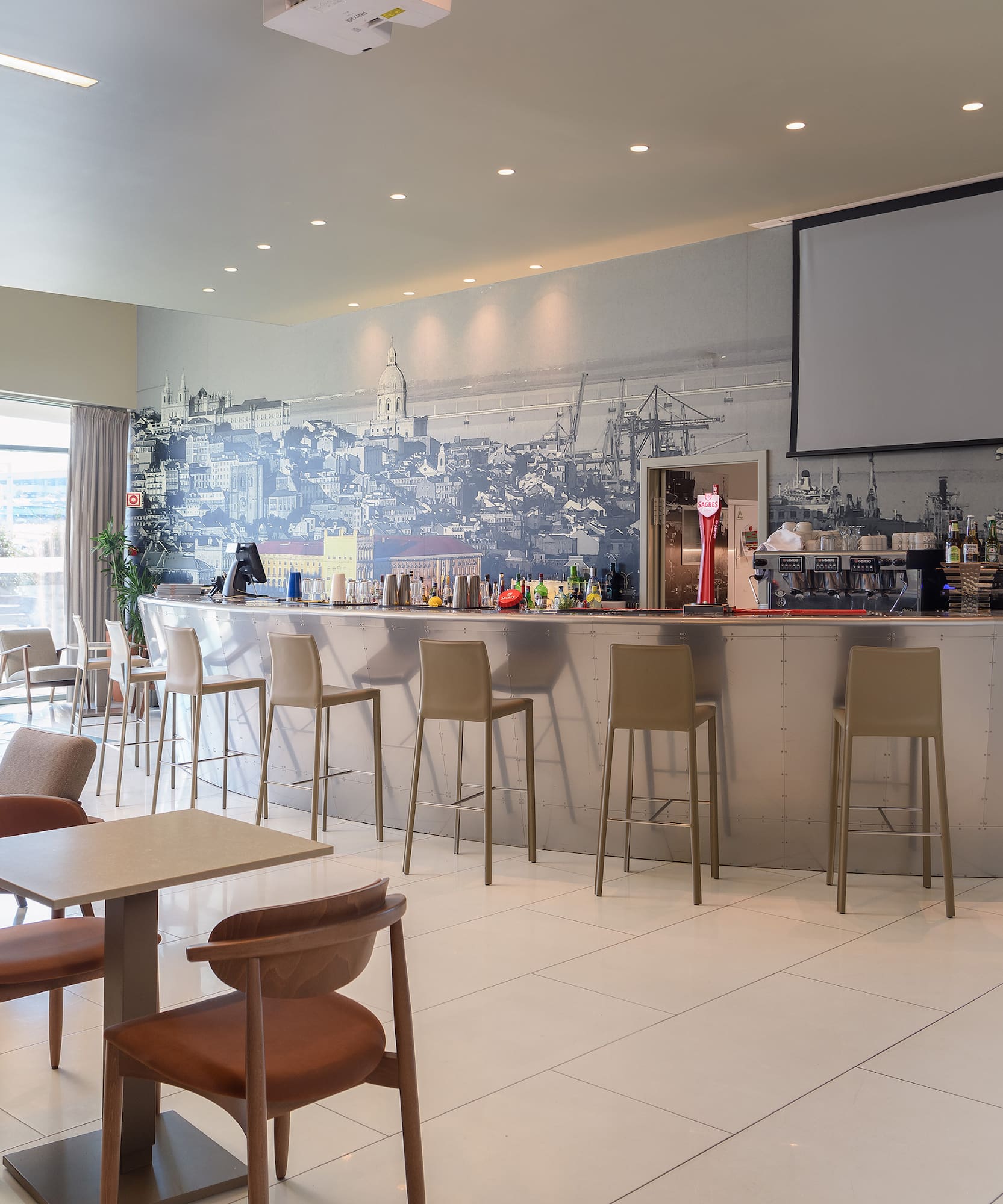 a room with a bar and chairs