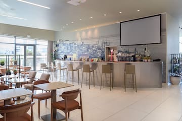 a room with a bar and chairs