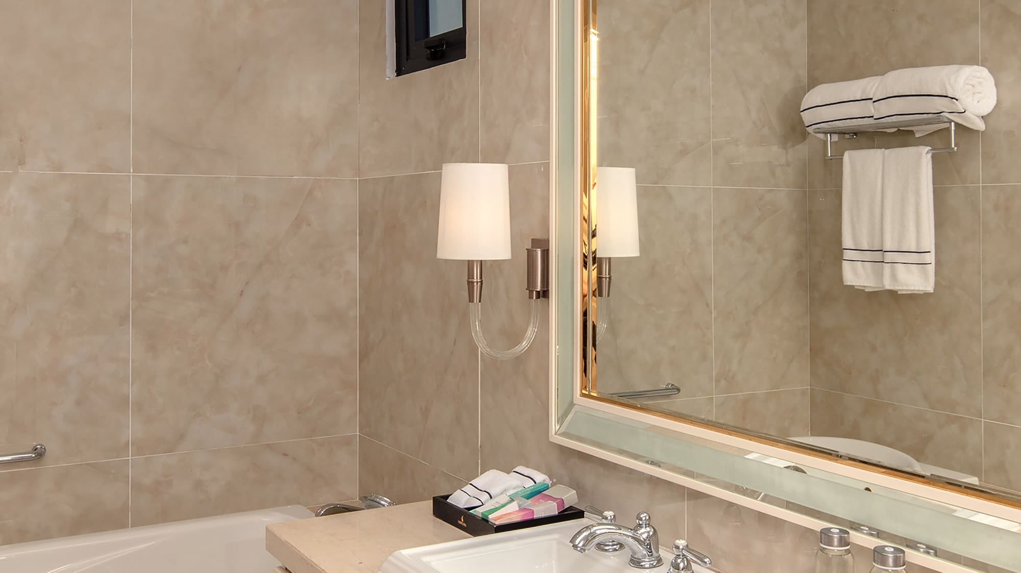 a bathroom with a mirror and sink