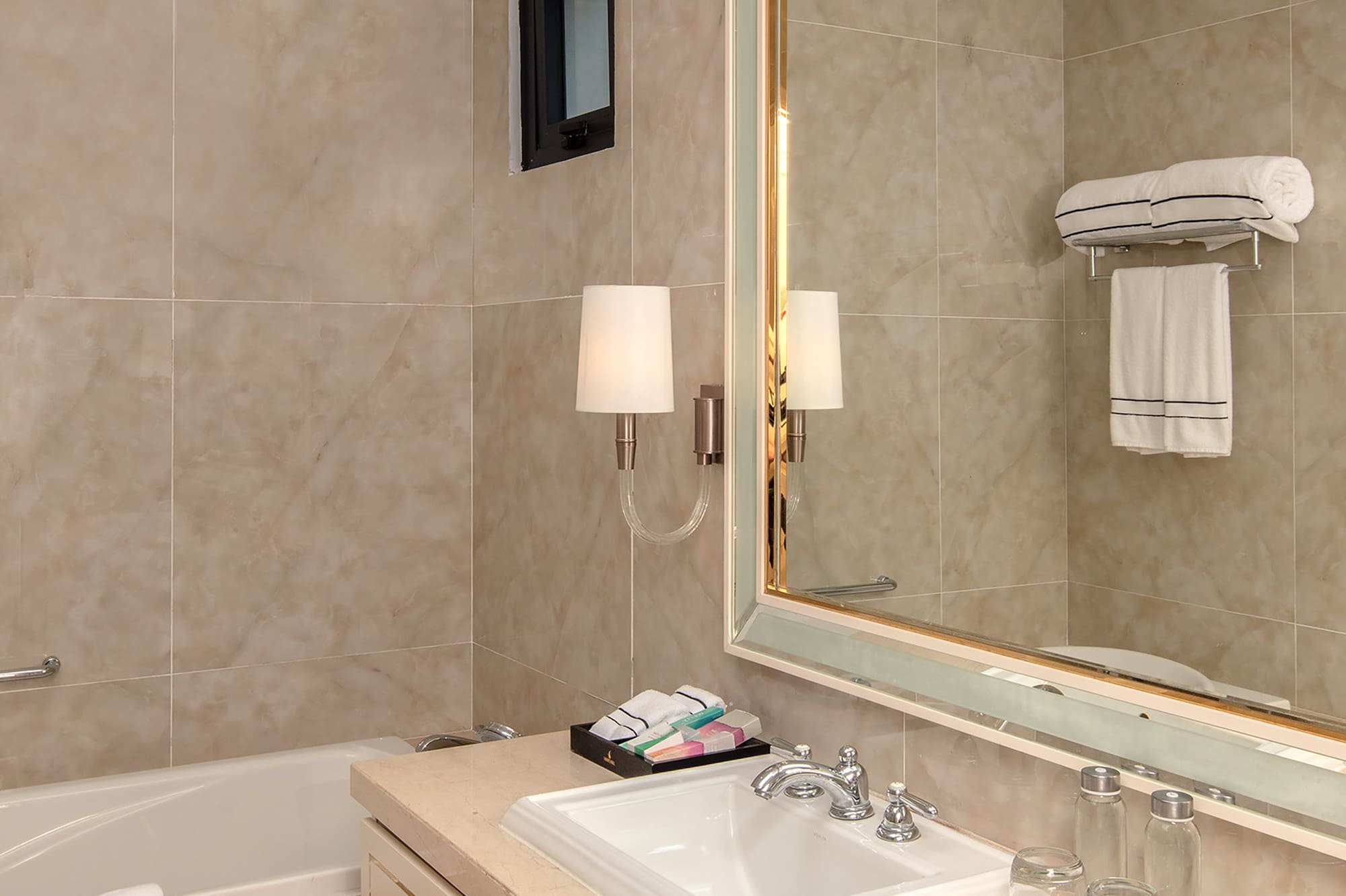 a bathroom with a mirror and sink