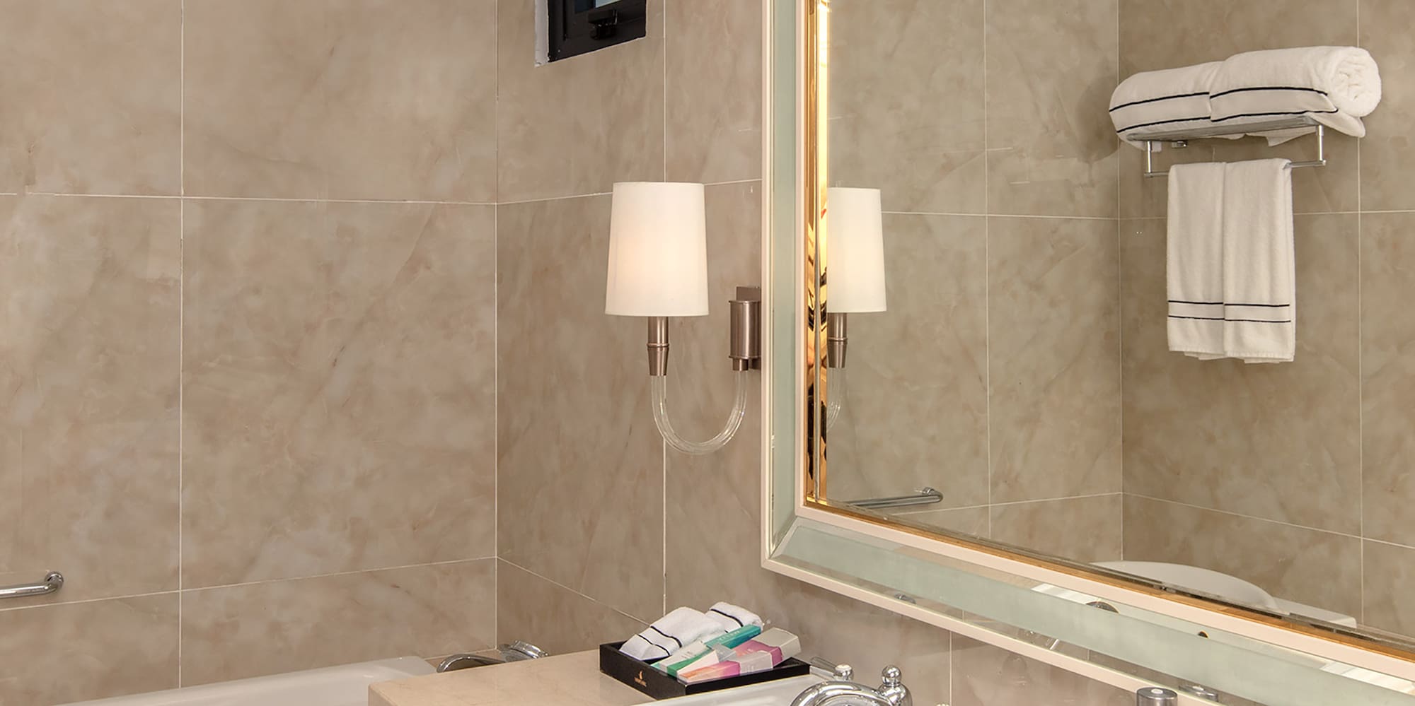 a bathroom with a mirror and sink