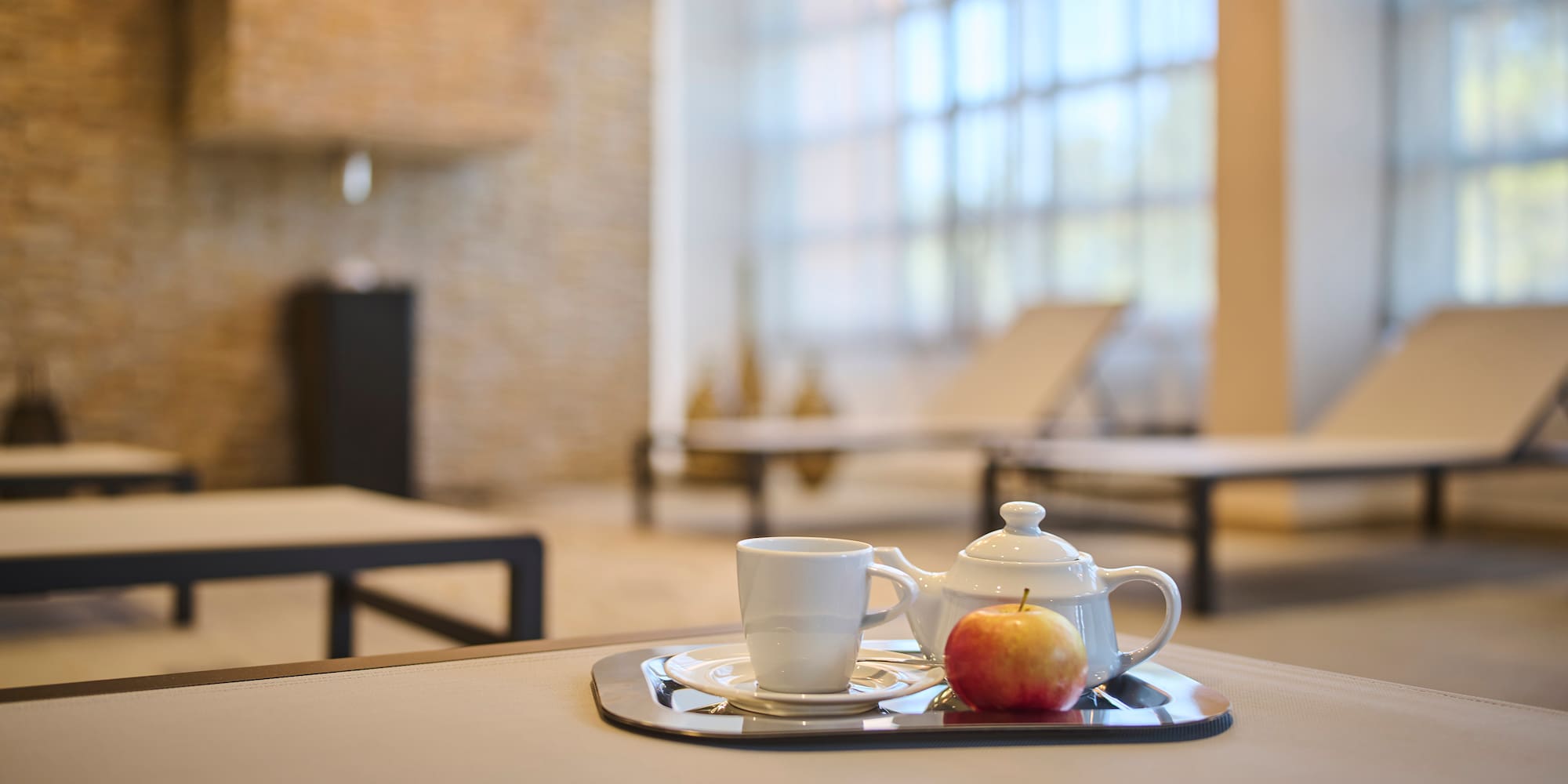 a teapot and a cup on a tray