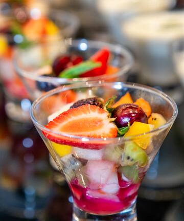 a group of glasses with fruit in them