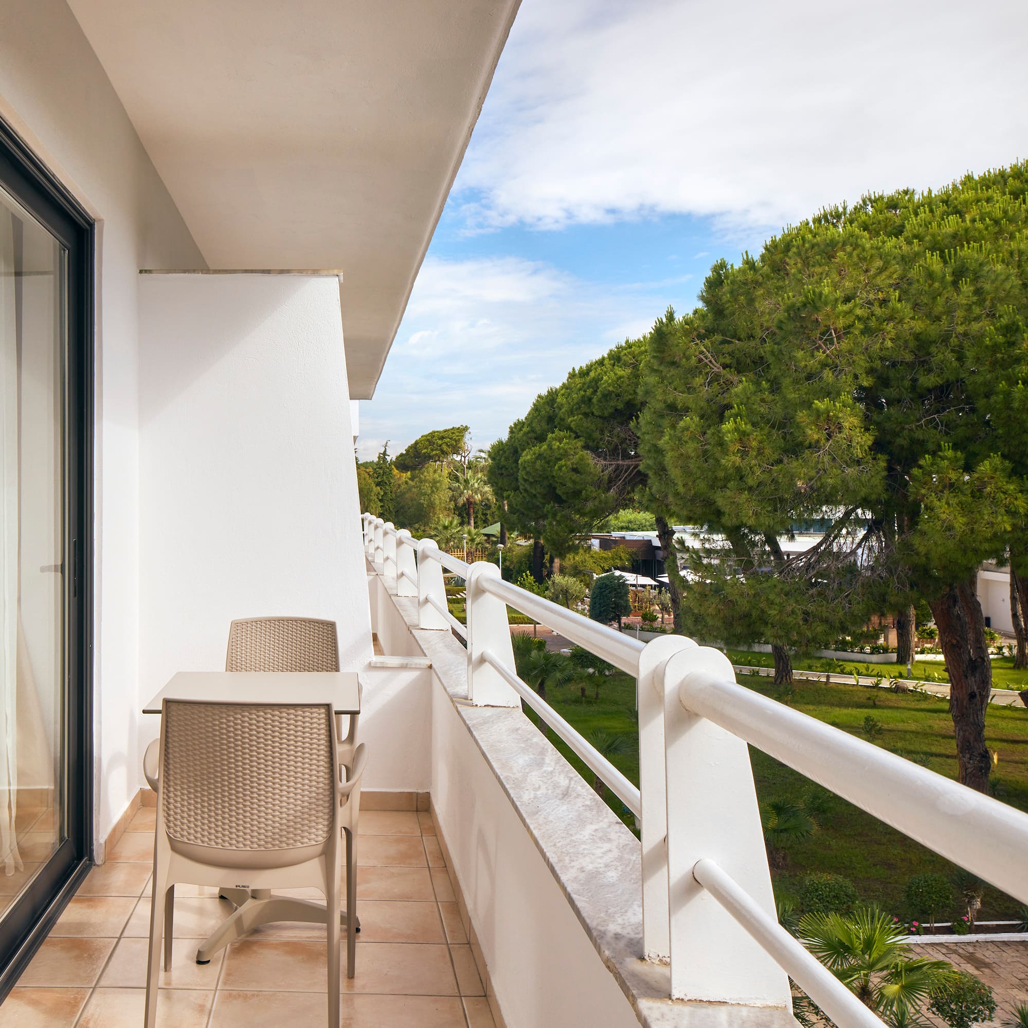 a balcony with chairs and a table