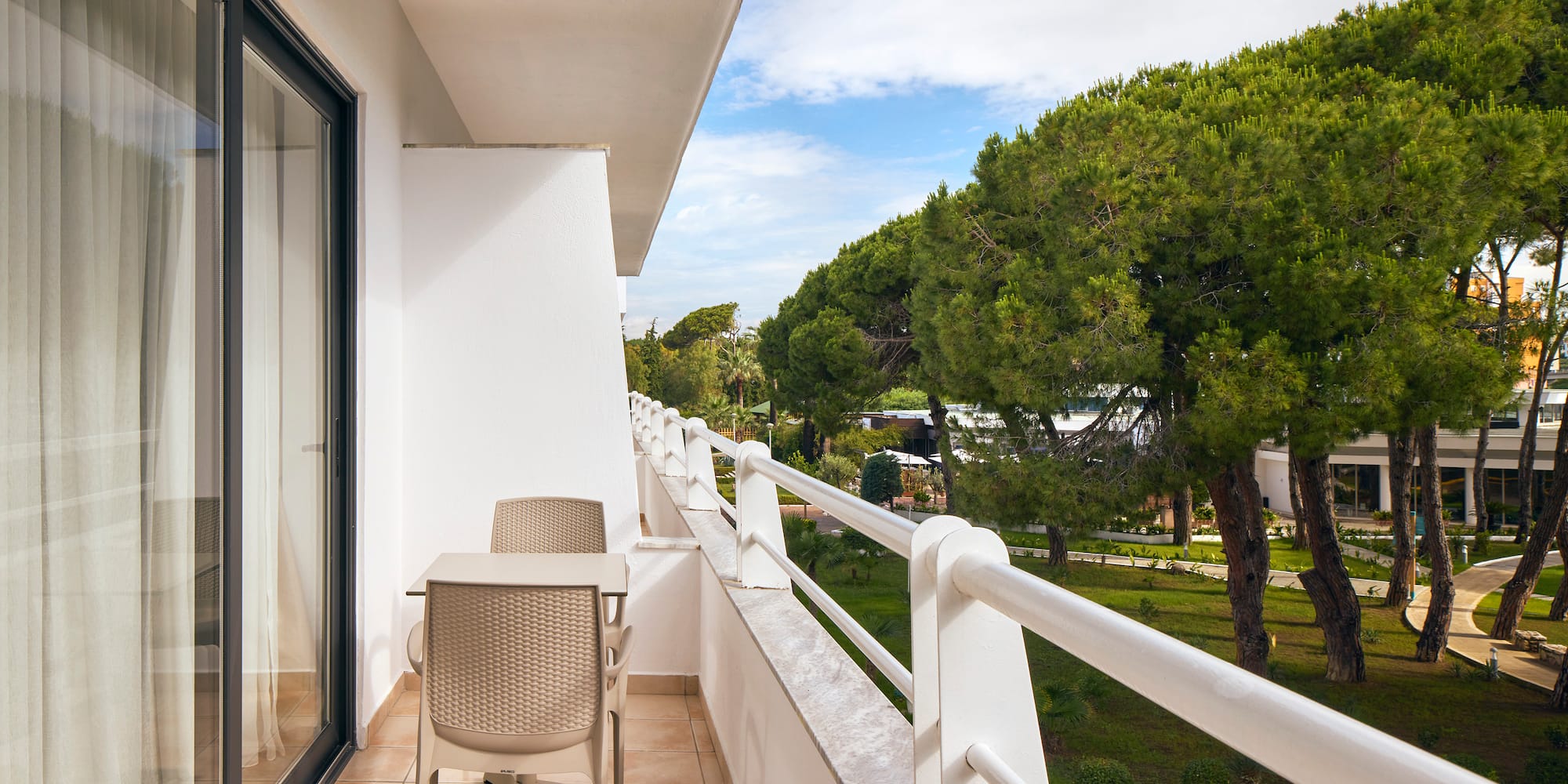 a balcony with chairs and a table