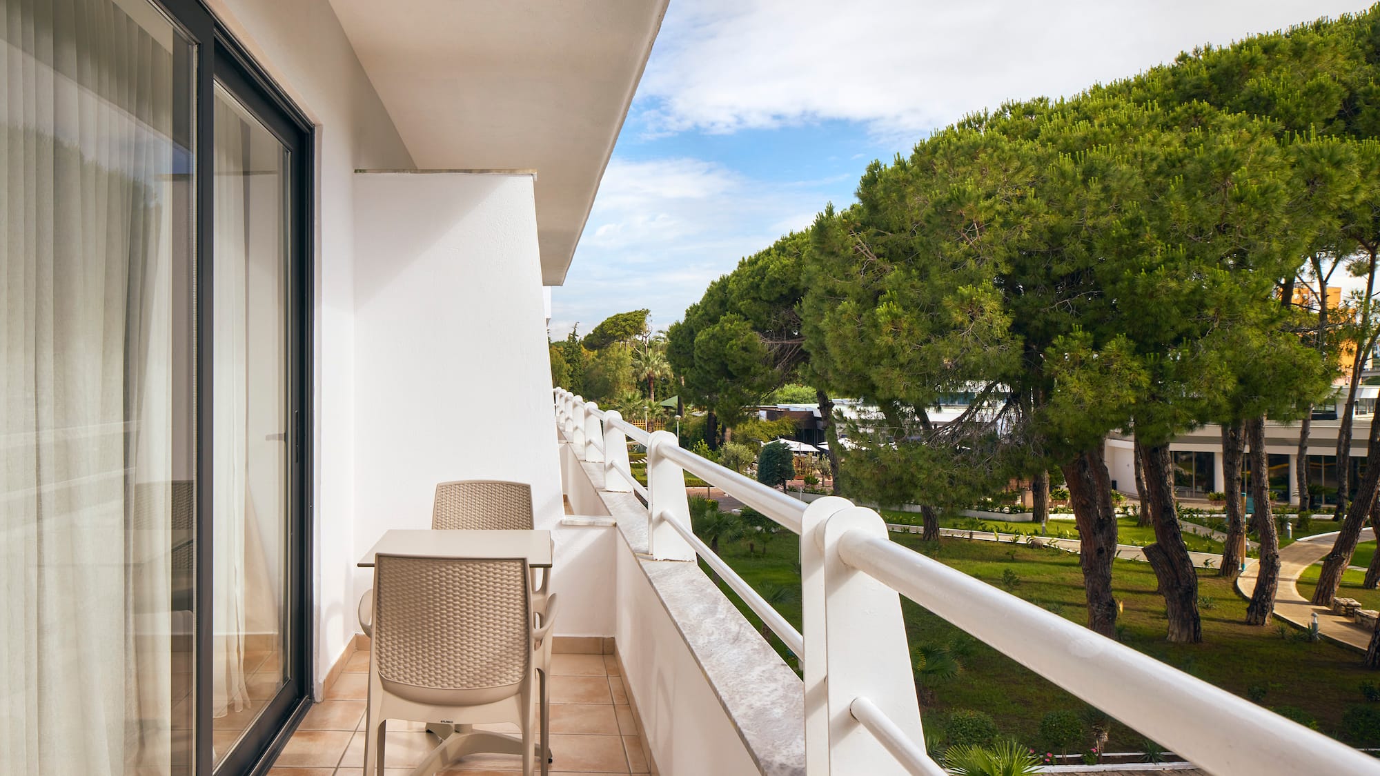 a balcony with chairs and a table