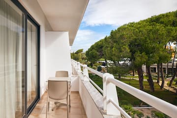 a balcony with chairs and a table