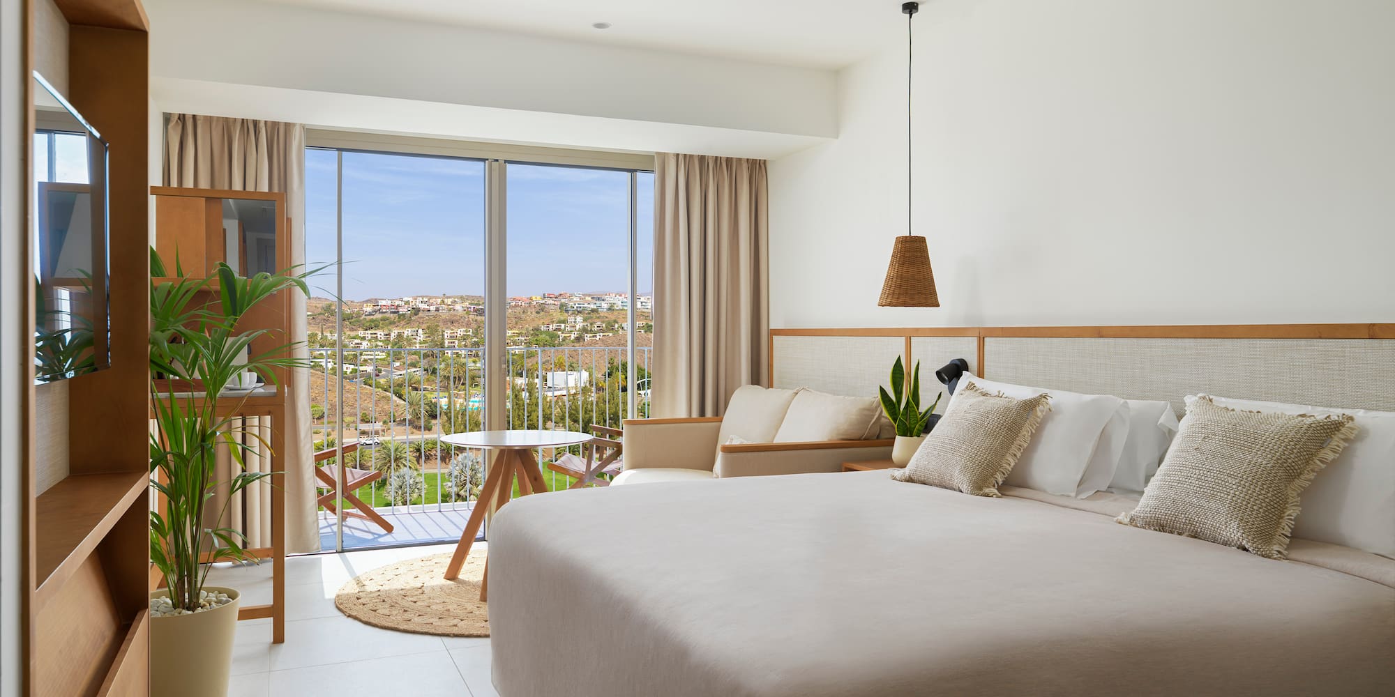 a bedroom with a large bed and a ceiling fan
