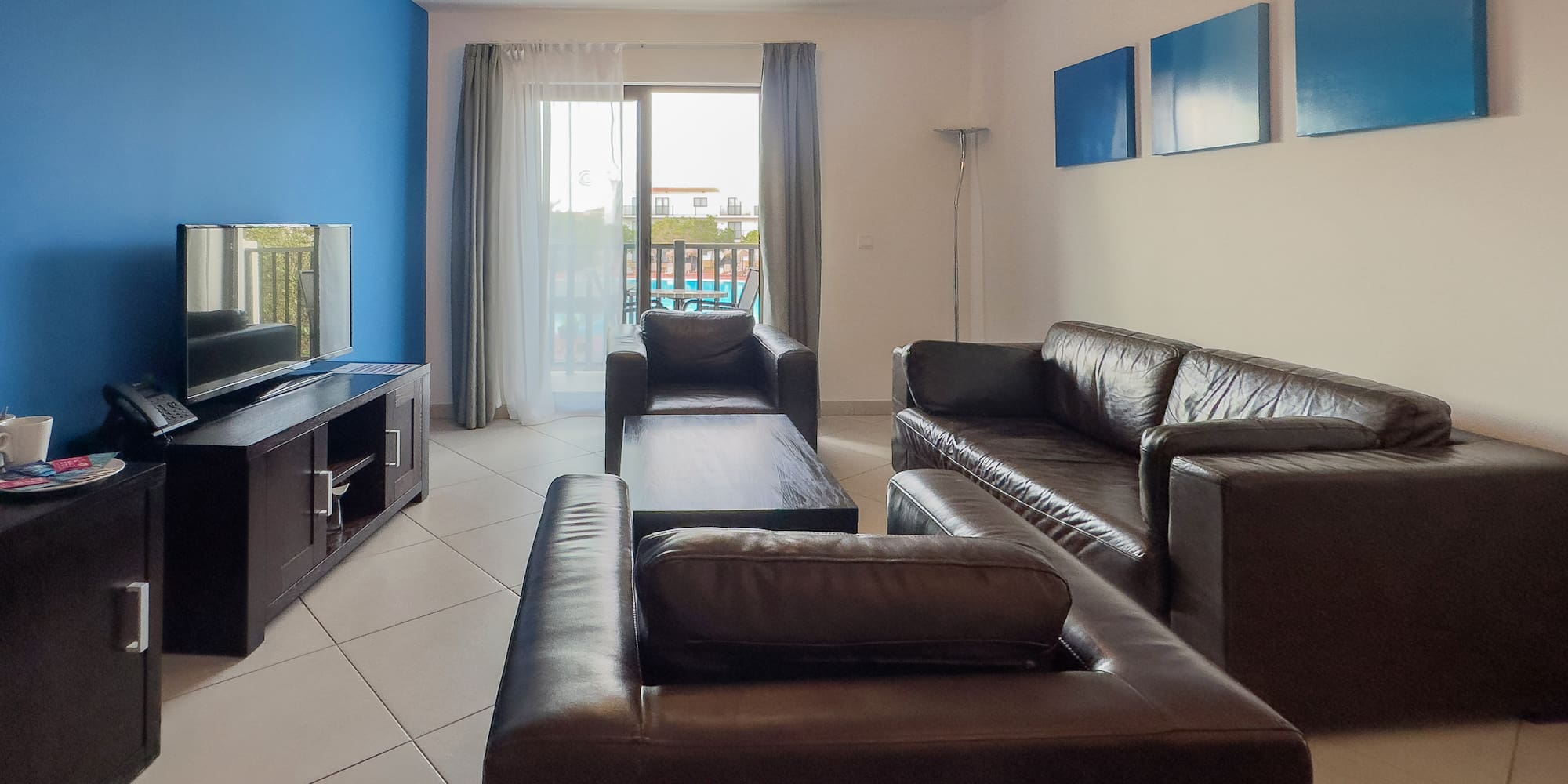 a living room with leather couches and a television