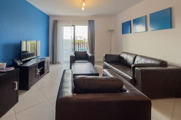 a living room with leather couches and a television